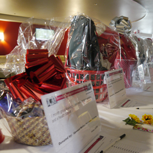 Gift baskets line the tables as part of the silent auction at the Southwest Fiesta Tailgate.